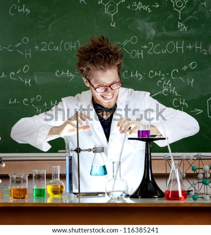 Laughing mad professor combines some liquids in his laboratory