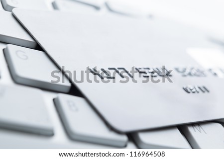 Close up of credit card on a pc keyboard. Concept of internet buying