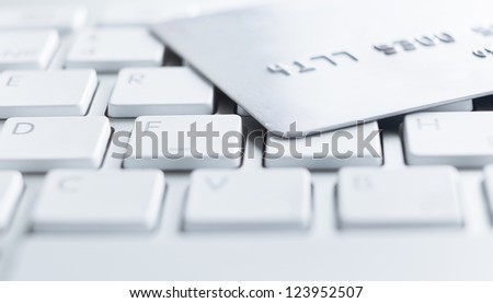 Close up of credit card on a computer keyboard. Concept of internet purchase