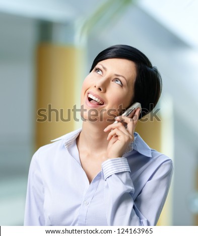 Business woman in business suit talks on cellphone. Leadership