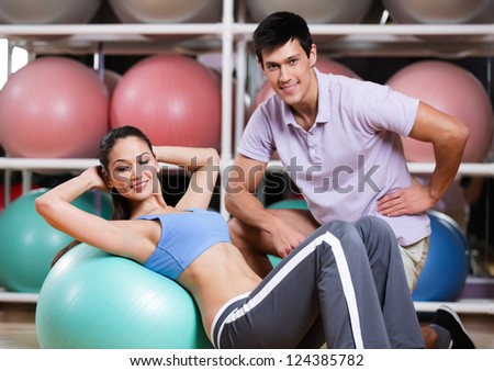 Woman exercises in fitness gym with couch