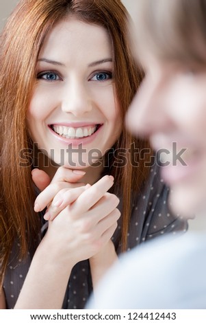 Smiley couple talks sitting at the table at the restaurant