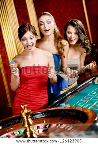 Three women playing roulette at the casino