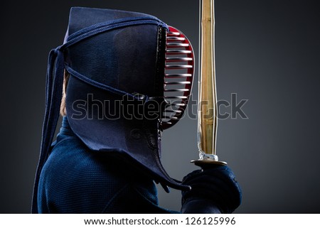 Profile of kendo fighter with shinai. Japanese martial art of sword fighting