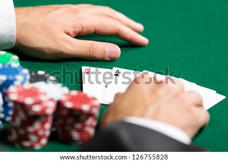 Poker player opens his cards. Challenge to the casino