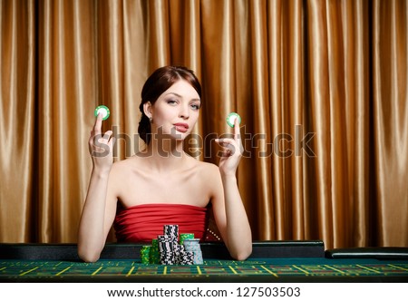 Woman with chips sitting at the casino table at the gambling house
