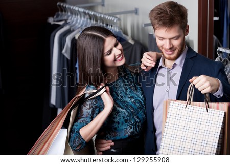 Attractive woman and young man go shopping at the store