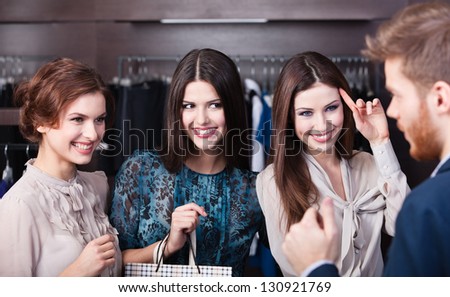 Three wonderful women flirt with salesperson