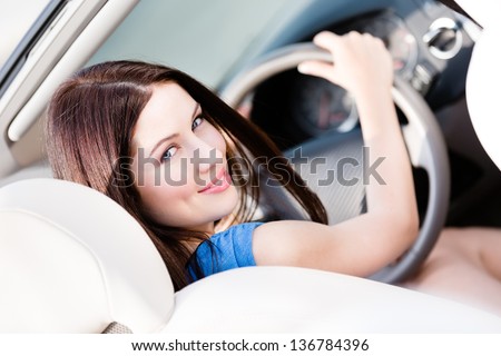 Portrait of pretty female driver turning back