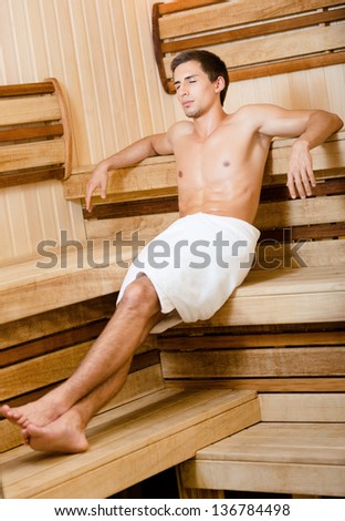 Half-naked male relaxing in sauna. Concept of self-care, health and relaxation