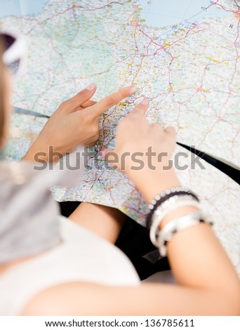 Girls lost their way and check the way with the help of the highway map