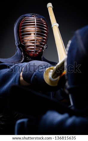 Close up of competition of two kendo fighters. Japanese martial art of sword fighting