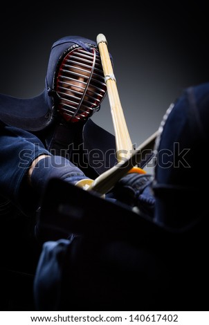 Close up view of competition of two kendo fighters. Japanese martial art of sword fighting