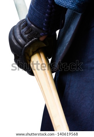 Close up of hand in kote with shinai, isolated on white. Japanese martial art of sword fighting