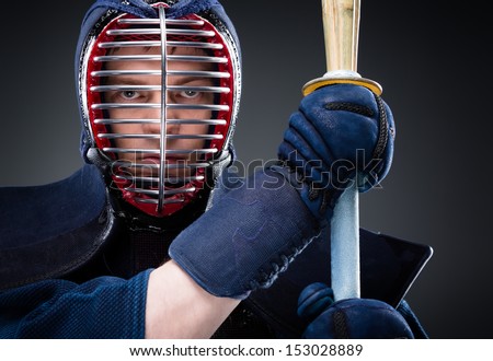 Close up of kendo fighter with shinai. Japanese martial art of sword fighting