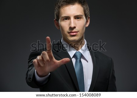 Half-length portrait of business man forefinger gesturing who wears business suit and black tie