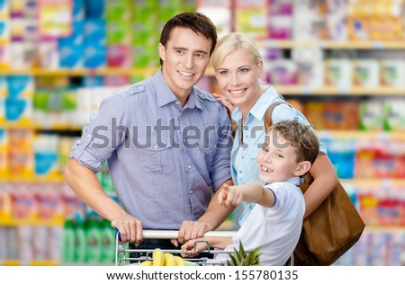 Half-length portrait of family in the shop. Concept of consumerism and family relations