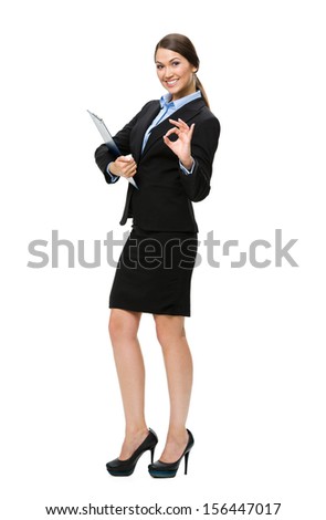 Full-length portrait of OK gesturing businesswoman with folder, isolated on white. Concept of leadership and success
