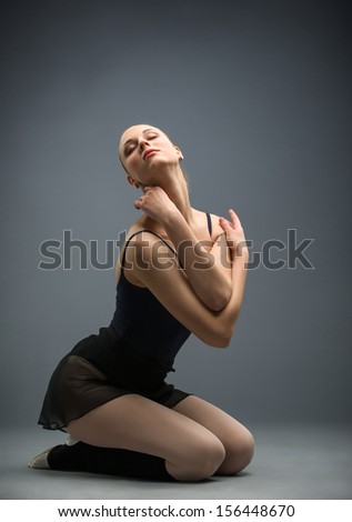 Dancing on the floor ballerina with her eyes closed, isolated on white on grey. Concept of elegant art and sportive hobby