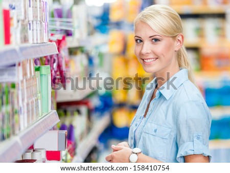 Portrait Of Young Girl At The Market Standing Near The Shelves With Cosmetics