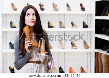 Woman Keeps Two Stylish Pumps In The Shopping Mall And Can\'T Choose The One For Her