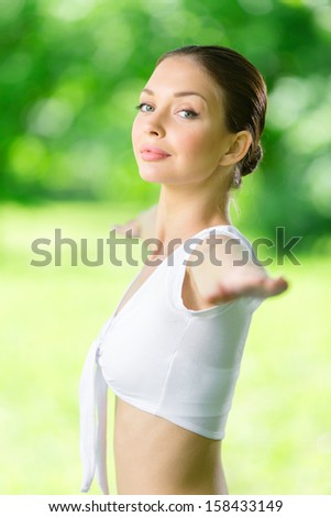 Portrait of woman with outstretched arms exercising. Concept of healthy lifestyle and relaxation