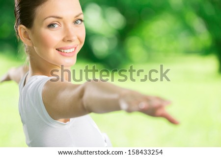 Portrait of girl with outstretched arms exercising. Concept of healthy lifestyle and relaxation