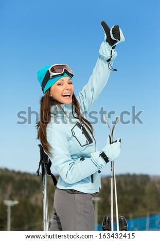 Half-length portrait of female skier thumbing up. Concept of winter sports and cute entertainment