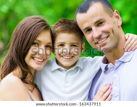 Portrait of family of three. Concept of happy family relations and carefree leisure time