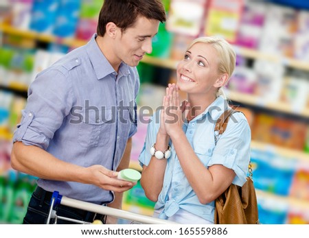 Wife asks husband to buy cosmetics for her. Concept of consumerism and family relations