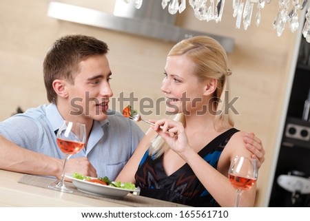 Husband and wife have dating dinner in the kitchen