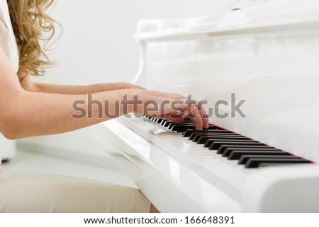 Close up view of hands playing piano. Concept of music and enjoyment