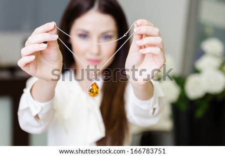 Woman Keeping Necklace With Yellow Sapphire At Jeweler\'S Shop. Concept Of Wealth And Luxurious Life