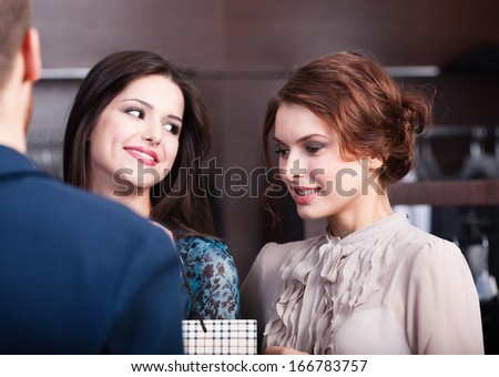 Two wonderful women talk to shop assistant