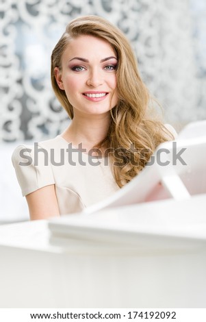 Portrait of woman sitting at the piano. Concept of music and art