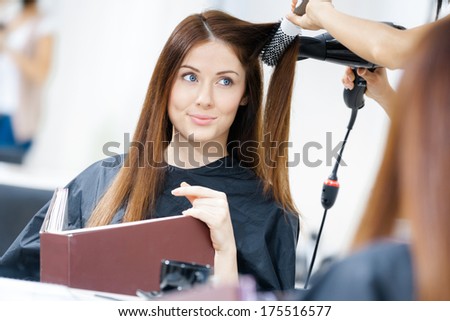 Reflection Of Hairdresser Doing Hair Style For Woman In Hairdresser\'S. Concept Of Fashion And Beauty