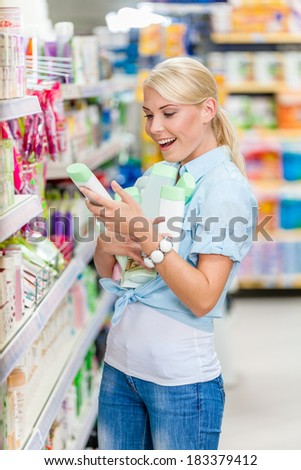 Girl at the store purchasing cosmetics among the great variety of products. Concept of consumerism, retail and purchase
