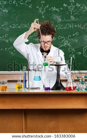 Mad professor conducts some chemical experiments in his laboratory