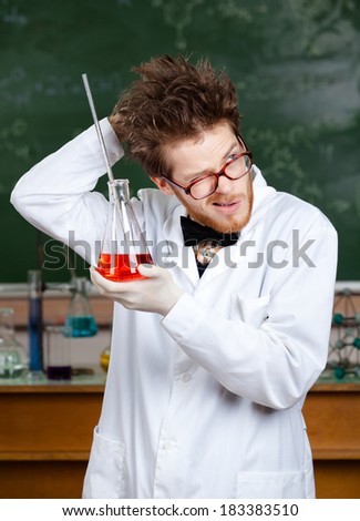 Mad professor scratches his head  handing flask