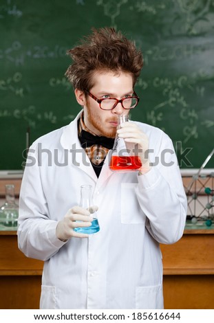 Mad professor smells liquid in the flask in his laboratory