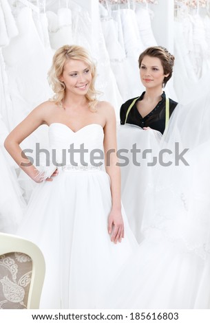 Girl is glad to put on this wedding dress, white background
