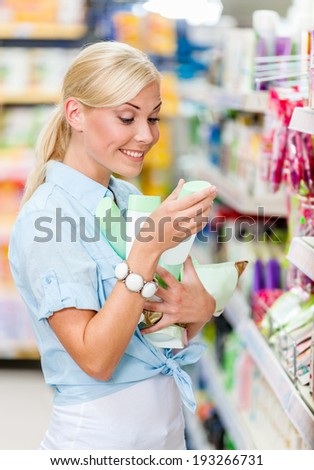 Girl at the market purchasing cosmetics among the great variety of products. Concept of consumerism, retail and purchase