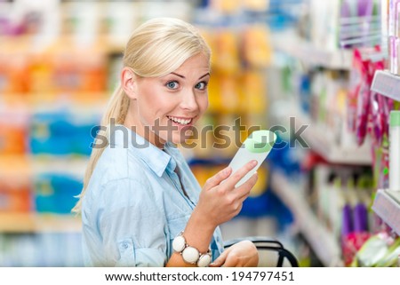 Woman at the shopping center choosing cosmetics among the great variety of products. Concept of consumerism, retail and purchase