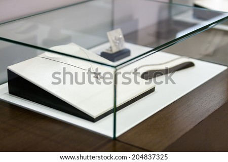 Jewelry in the window case at jeweler\'s shop. Concept of wealth and luxurious life