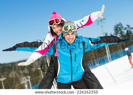 Half-length portrait of happy couple of alps skiers have fun. Concept of winter sports and cute vacations