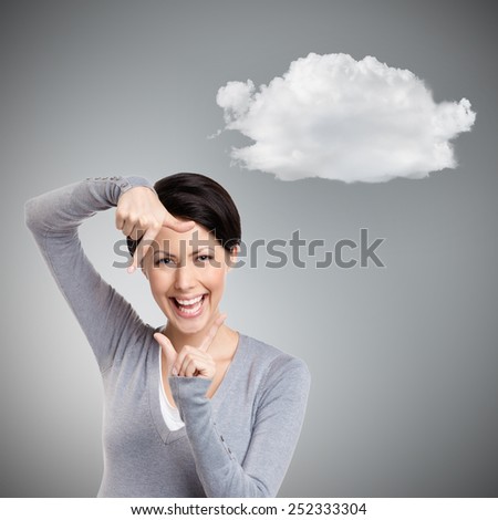 Amazing young girl gestures hand frame, isolated on grey background with cloud