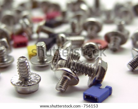 A lot of computer screws and jupper switches