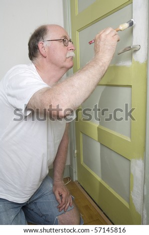 house painter is painting a door