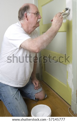 house painter is painting a door