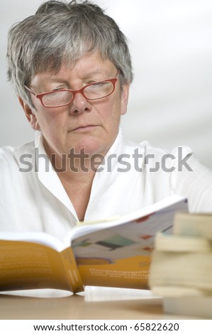 Adult women studying while reading a book